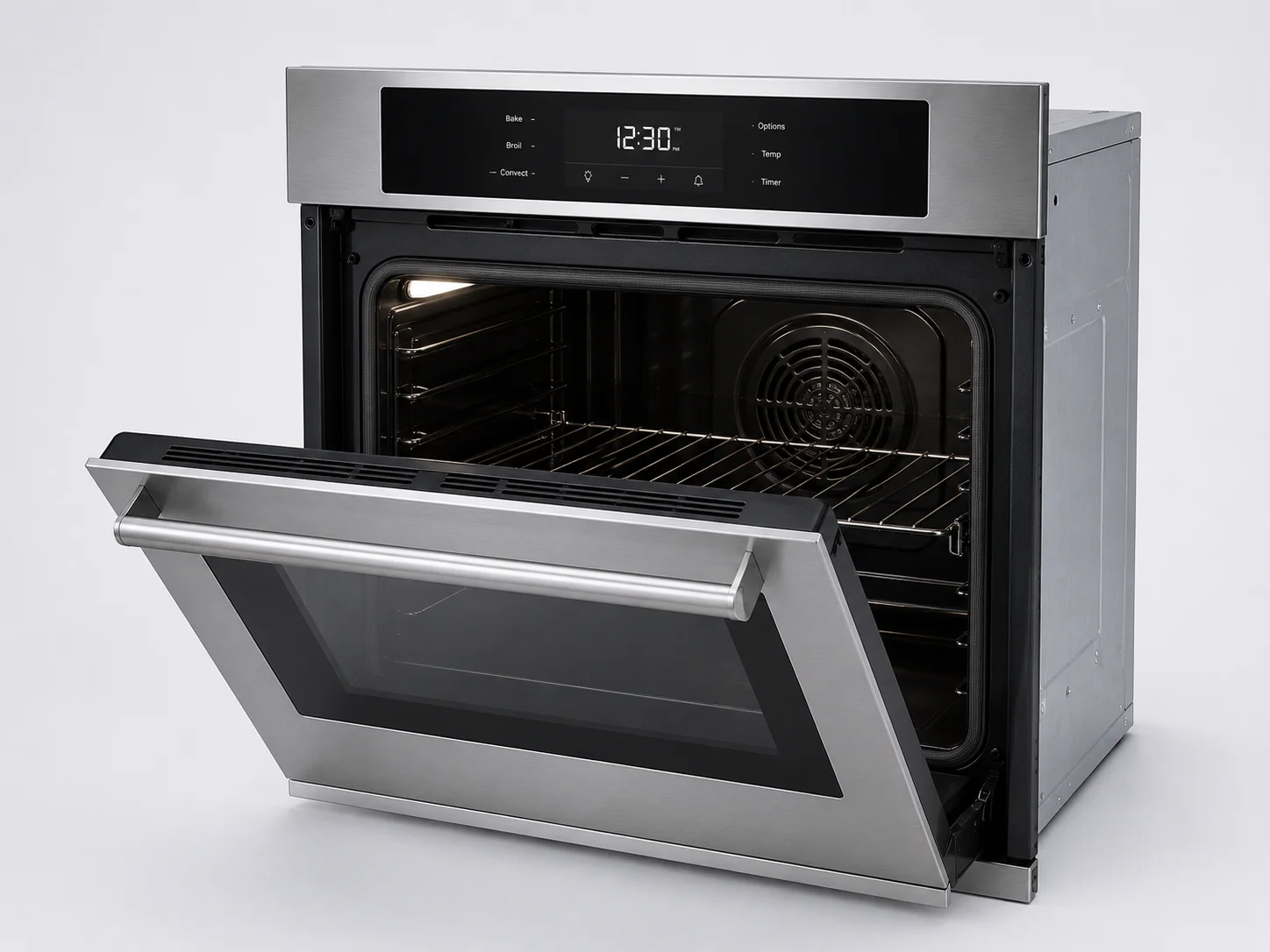 Technician kneeling at open wall oven reaching towards back heating element